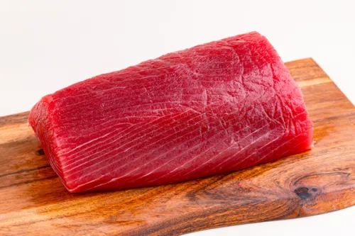 Sushi-grade tuna loin on a wooden board
