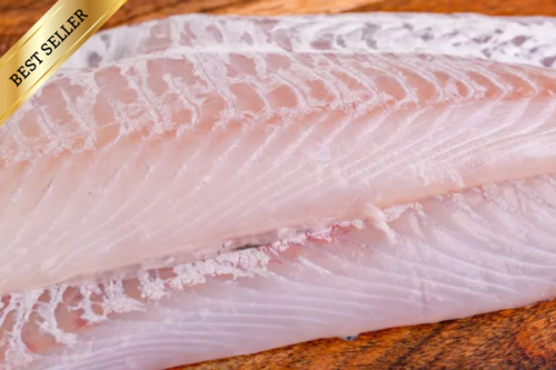 Fresh haddock fillets on a wooden board with a bestseller ribbon