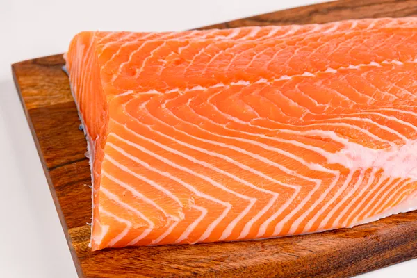 Fresh salmon fillet on a wooden board