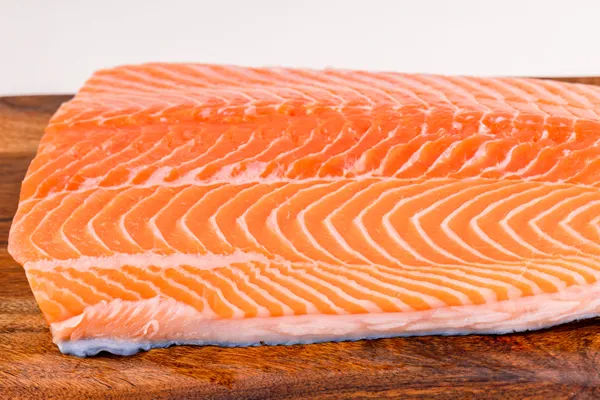 Fresh salmon fillet on a wooden board