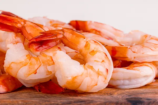 Cooked shrimp arranged on a wooden board