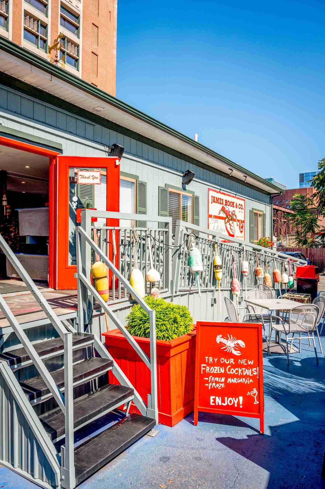240829_Interior&Exterior_1126_ James Hook & Co. Boston restaurant exterior with outdoor seating and a frozen cocktails sign
